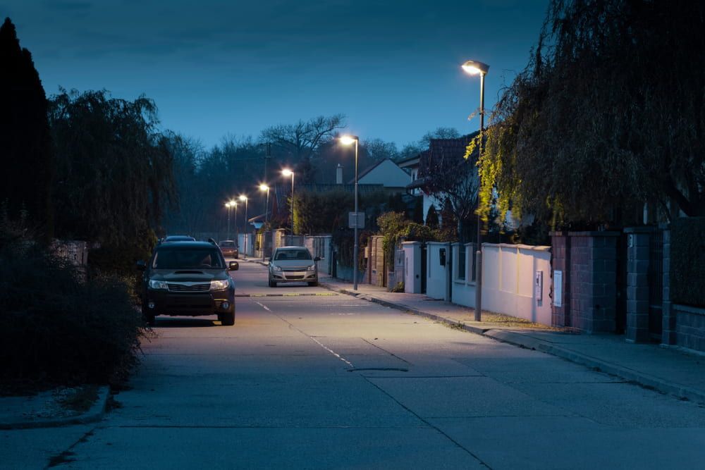 A Row of Cars Are Parked on A Snowy Street at Night — Jason Wenta Electrical Services in Condon, QLD