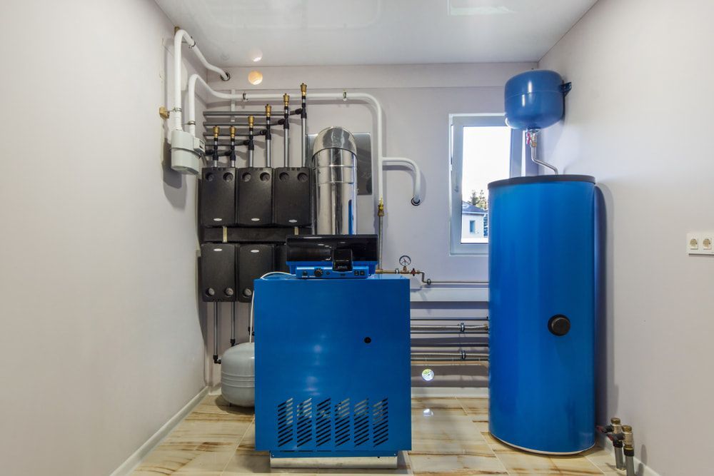 A Room with A Blue Water Heater and A Blue Tank — Jason Wenta Electrical Services in Condon, QLD
