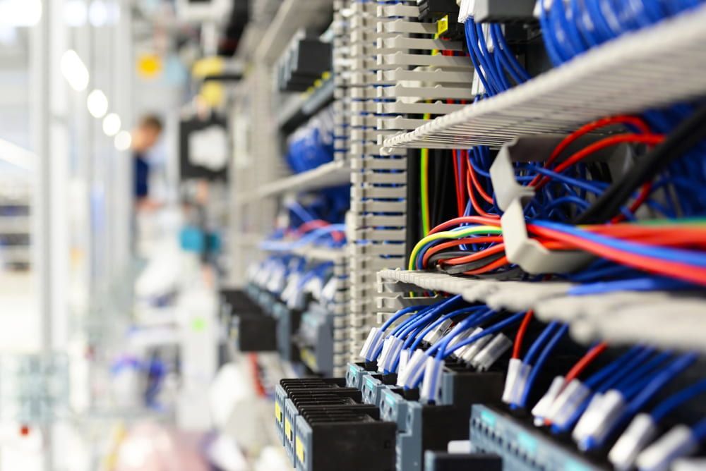 A Bunch of Wires Are Sitting on A Shelf in A Room — Jason Wenta Electrical Services in Condon, QLD
