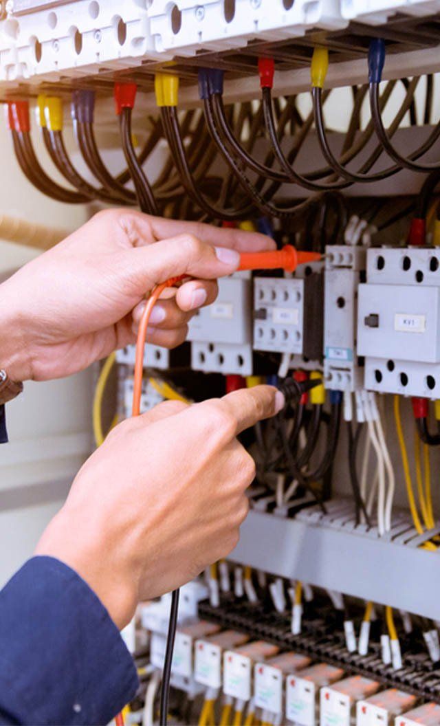 A Person Is Working on An Electrical Panel with A Screwdriver — Jason Wenta Electrical Services in Condon, QLD