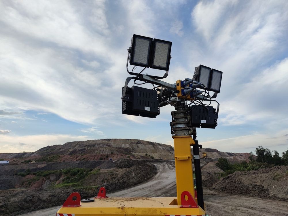 A Yellow Tower with A Lot of Lights on It Is Sitting on Top of A Dirt Road — Jason Wenta Electrical Services in Condon, QLD