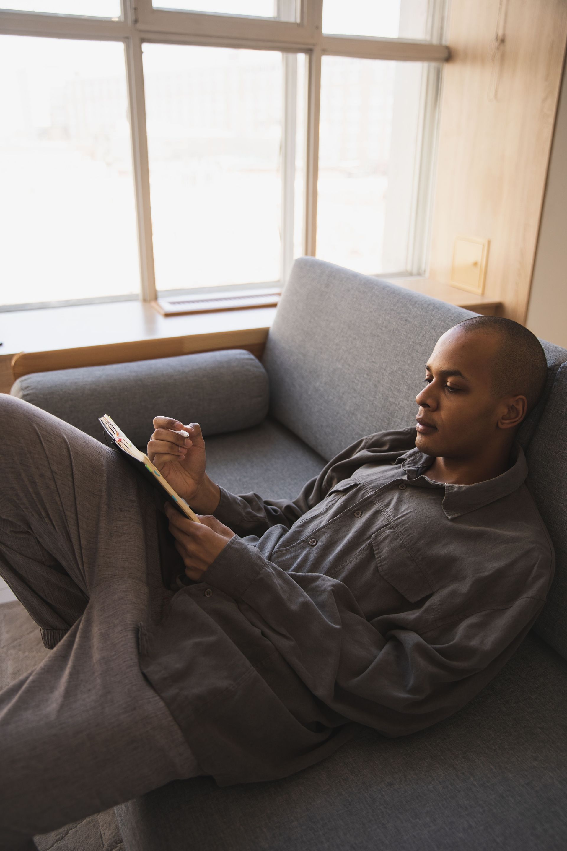 Colorado man planning his life insurance coverage amount with a notepad at home.