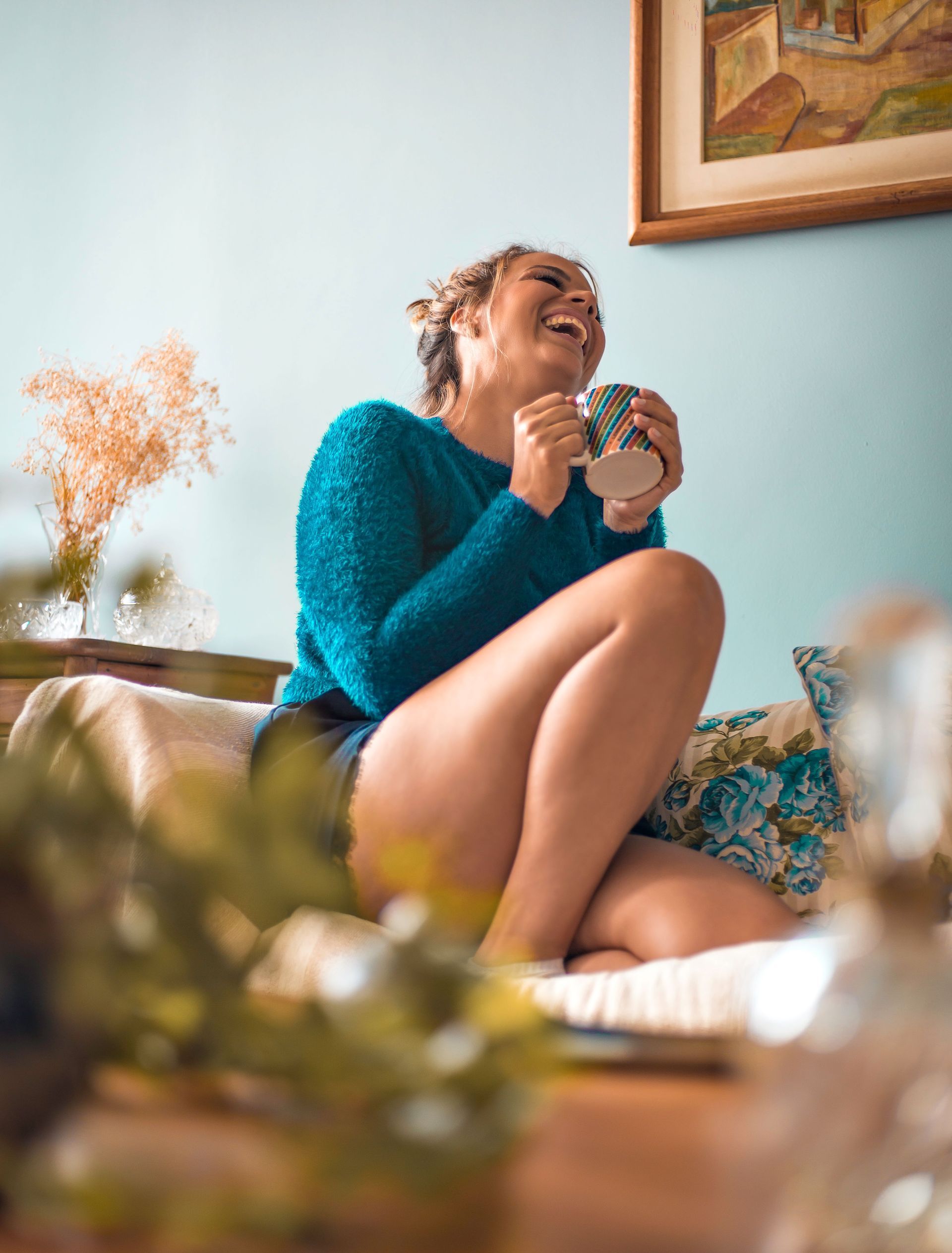 Colorado woman relaxed at home with tea after getting no-exam life insurance, no medical exam needed.