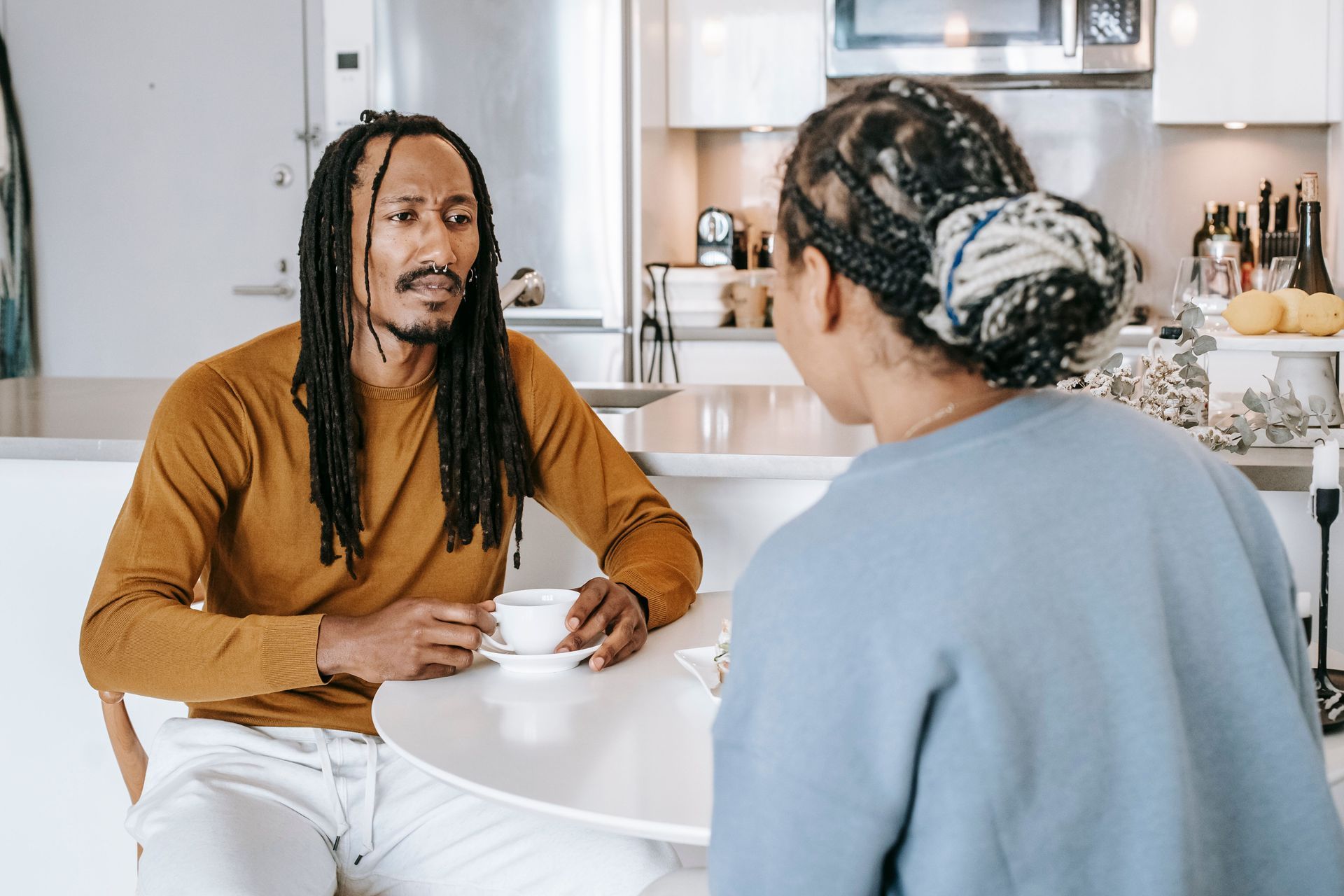 Colorado couple talking over coffee about term versus whole life insurance choices.