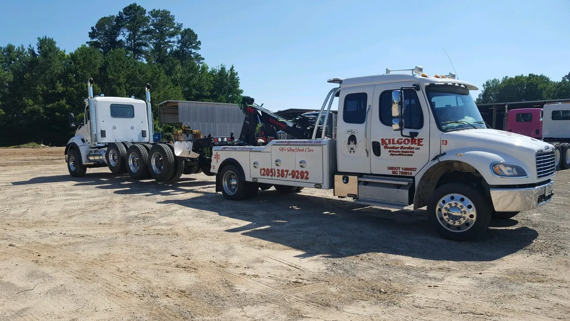 A white tow truck with the word welcome on it.
