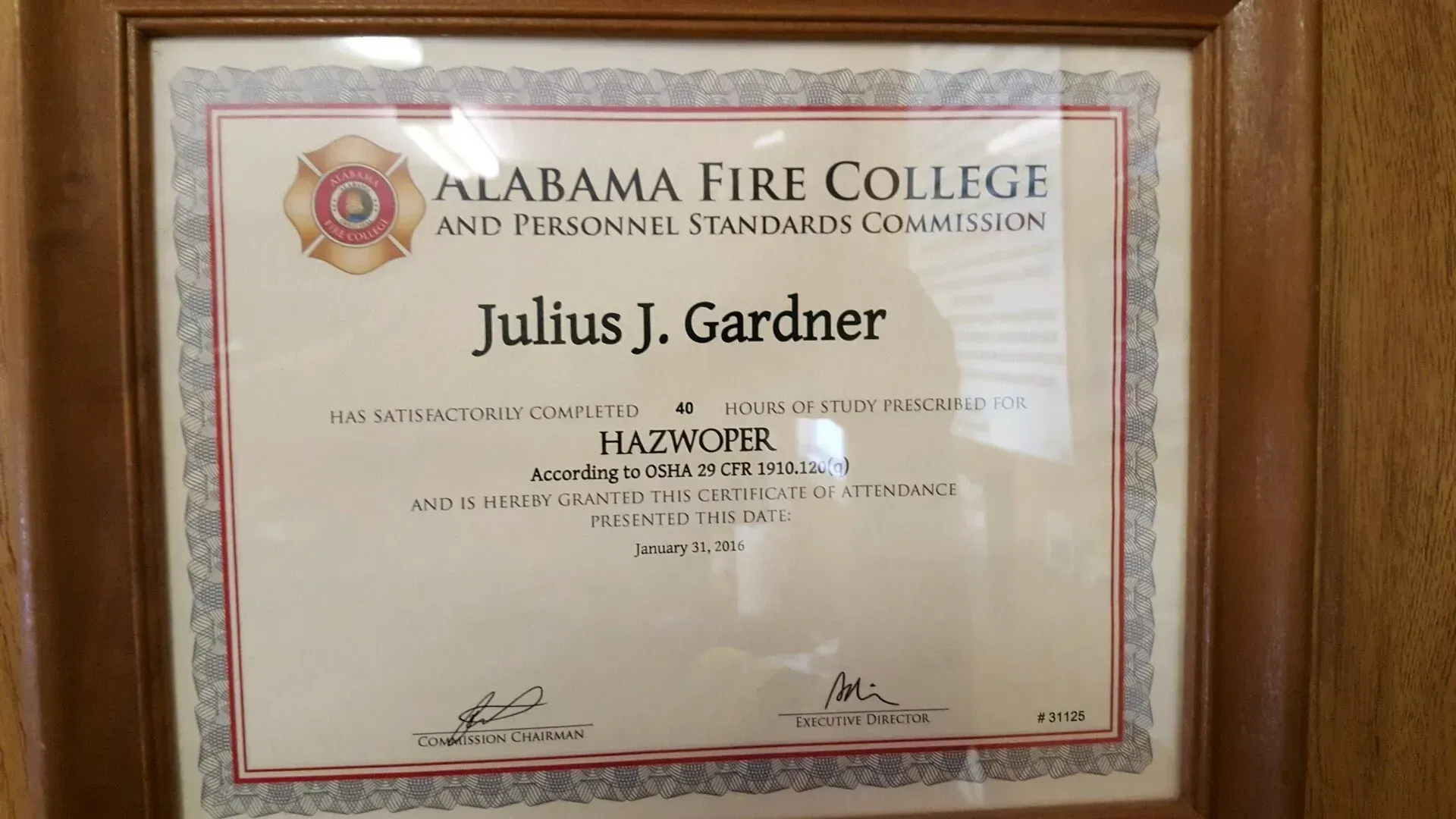 A framed certificate from the alabama fire college.