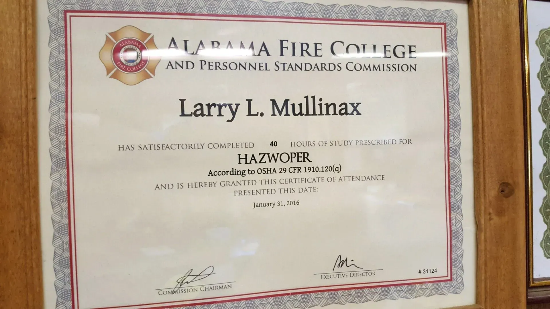 A framed certificate from the alabama fire college.