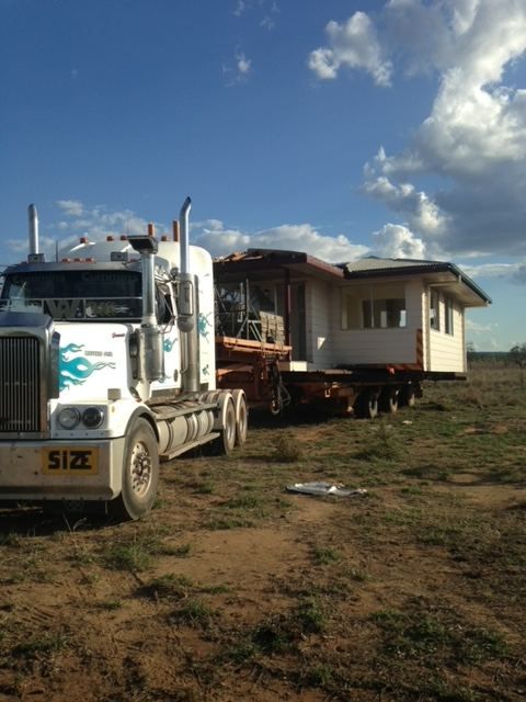 A White Semi Truck with A License Plate that Says Size — Conan The House Lifter In Townsville, QLD