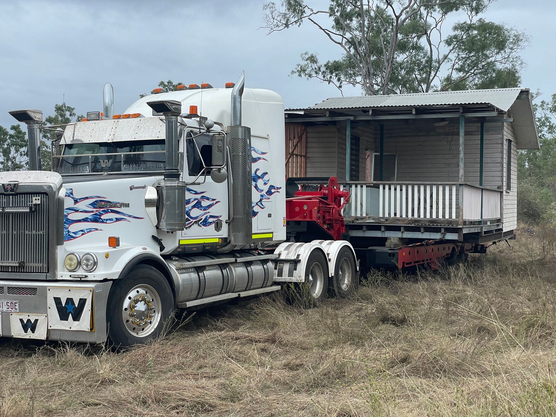 A Semi Truck is Pulling a Trailer with a House on it — Conan The House Lifter In Townsville, QLD