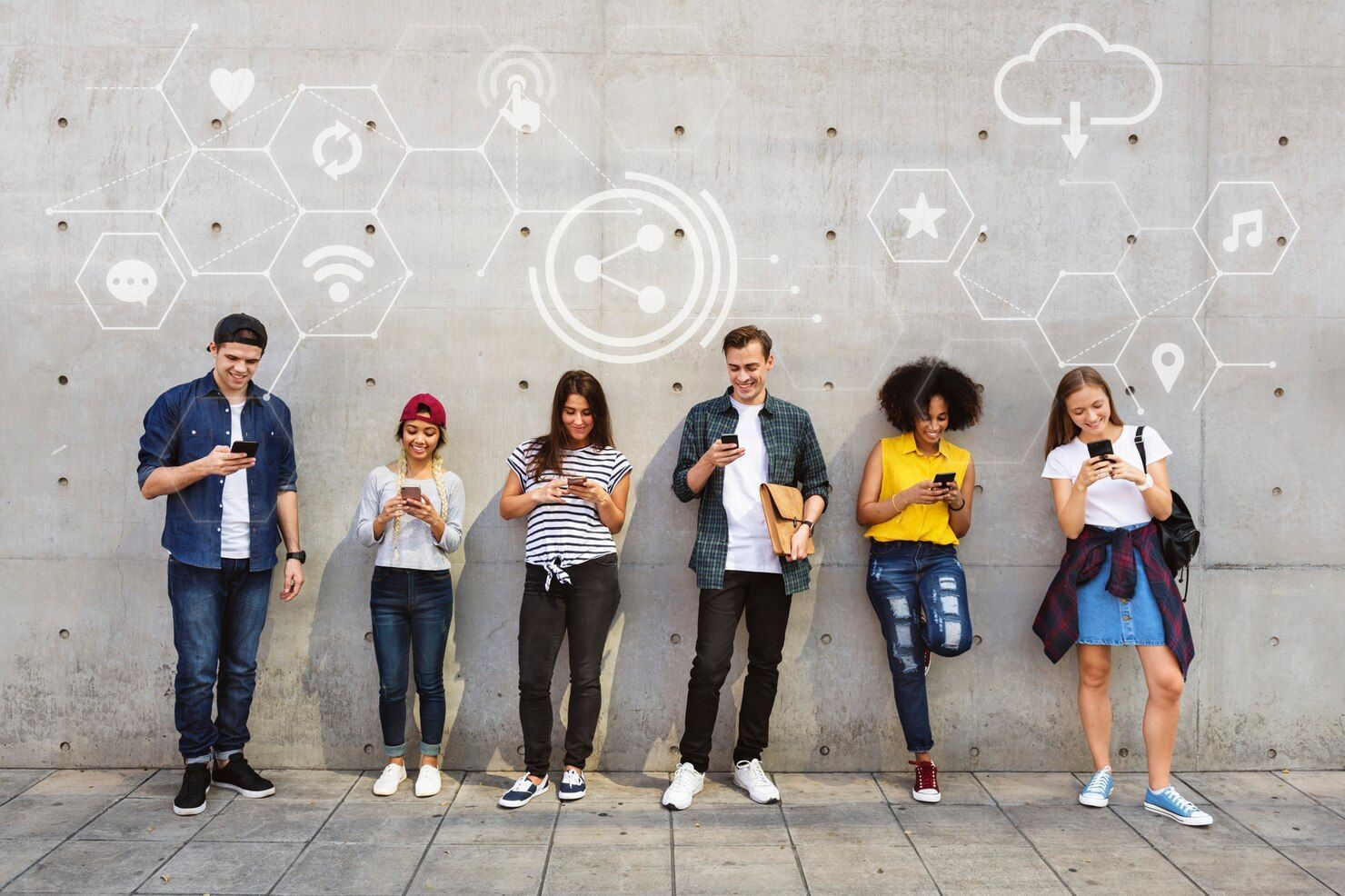 Six people standing against a gray wall with social media icons, using smartphones and coffee cups