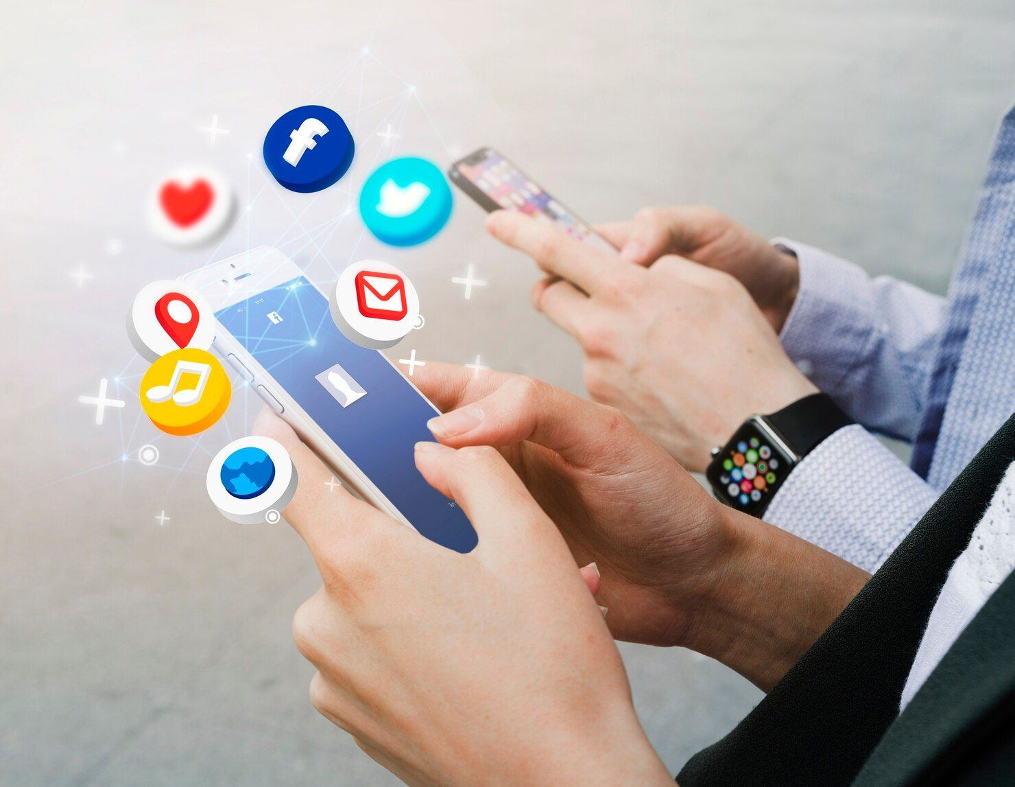 Hands using smartphones with floating social media notification icons around them.