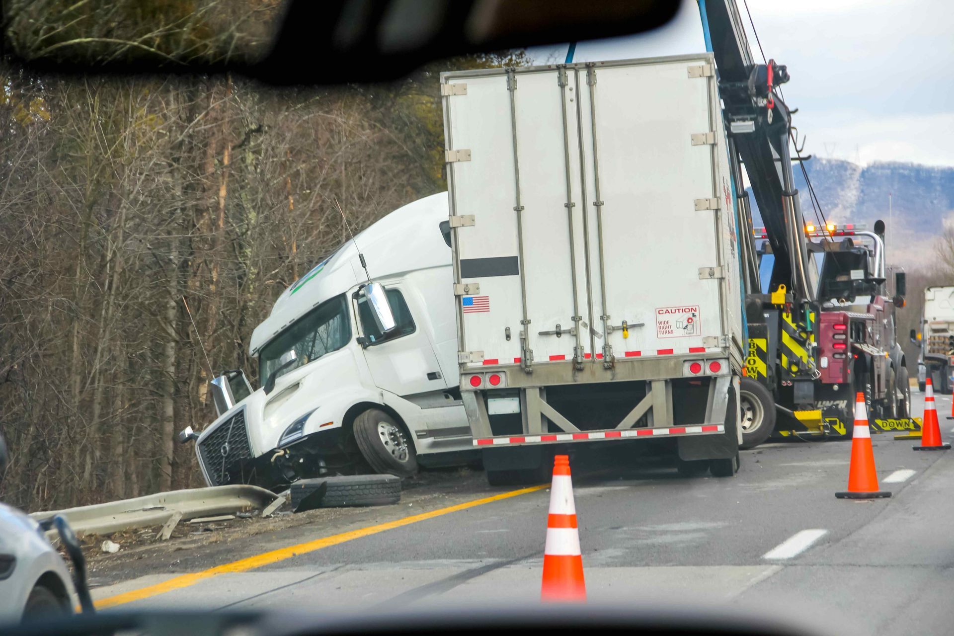 A picture of a semi-truck collision on the side of a highway for  this section Trucking Accidents.