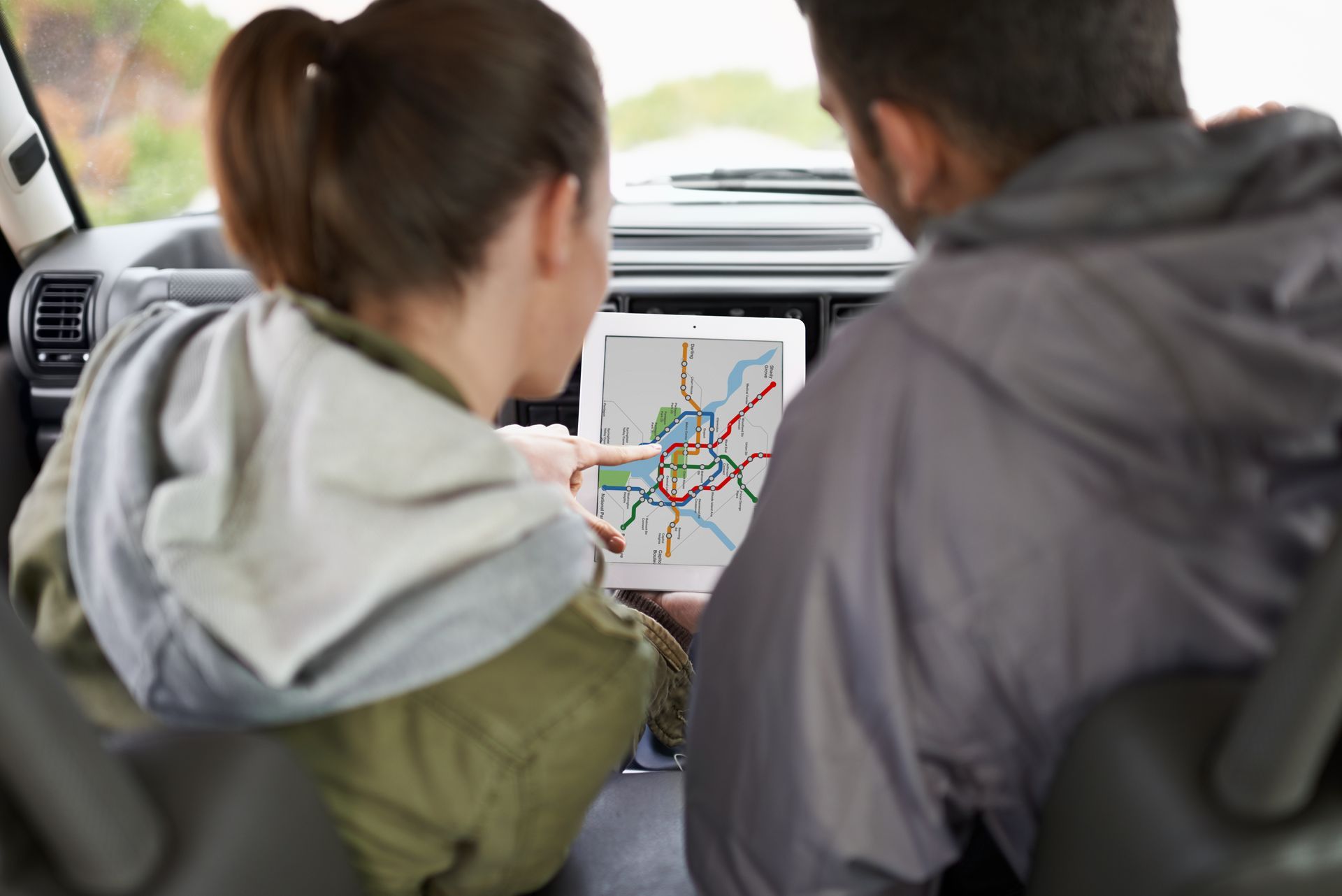 Passengers using GPS navigation on tablet during Arizona road trip to avoid getting lost