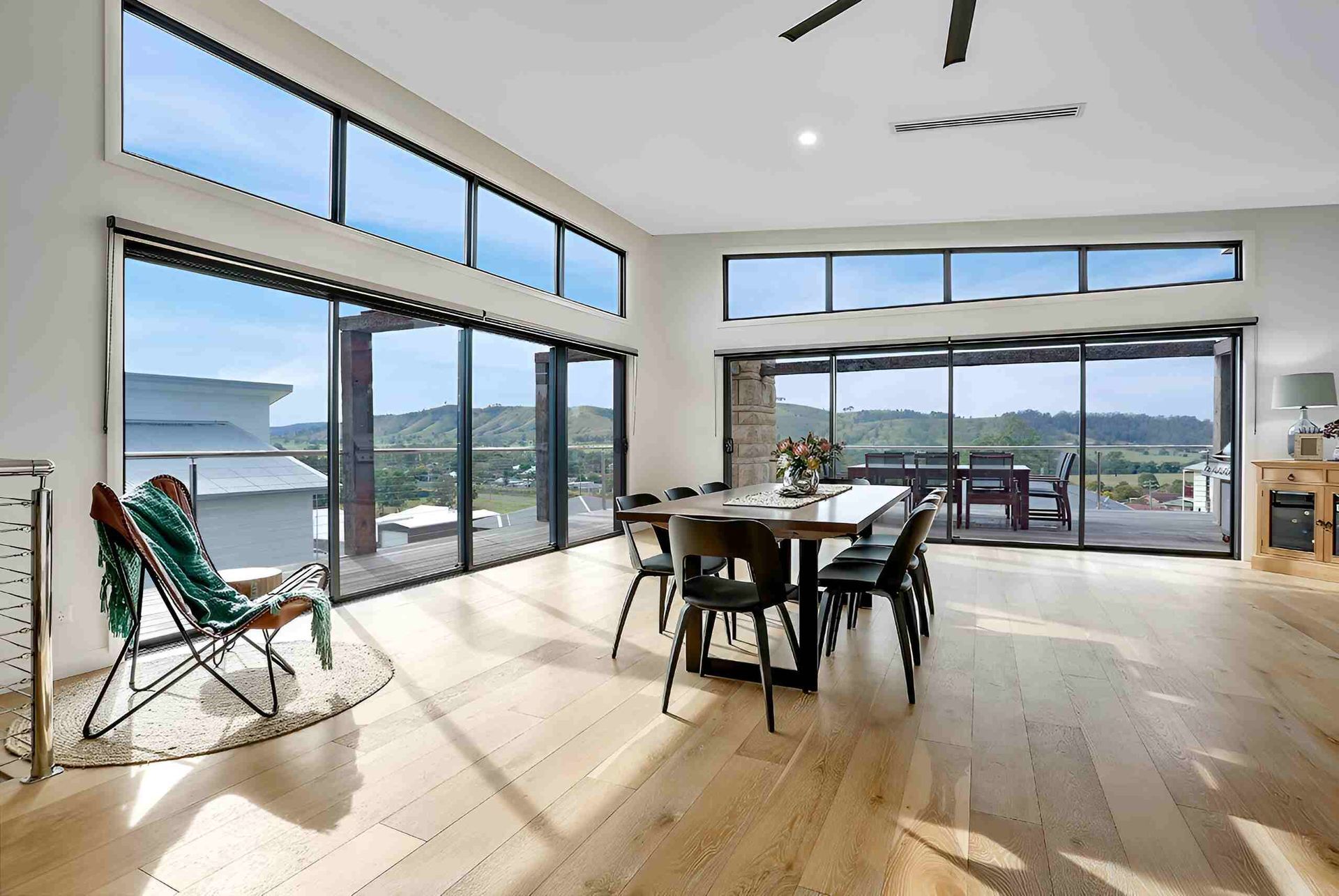 A Living Room With A Dining Table And Chairs And A Large Window — A & C Classic Window Tinting In Maitland Vale, NSW