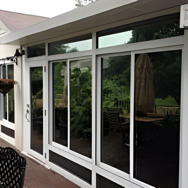 A House With A Lot Of Windows And Sliding Glass Doors — A & C Classic Window Tinting In Maitland Vale, NSW
