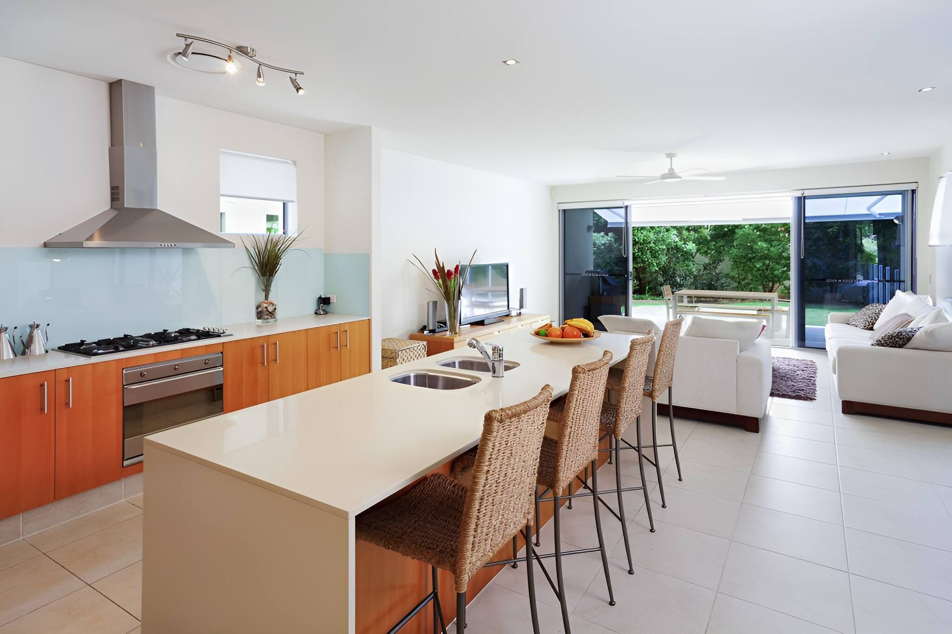 A Kitchen With A Long Island And Wicker Chairs — A & C Classic Window Tinting In Maitland Vale, NSW