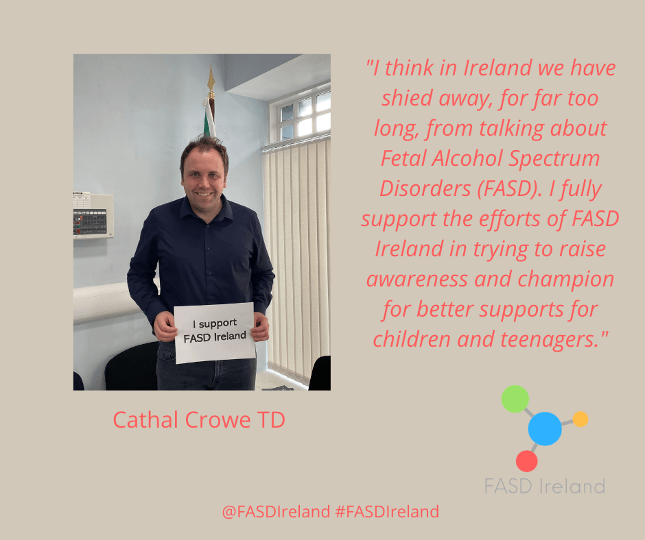 Cathal Crowe TD, holding a sign that says he is supporting FASD Ireland