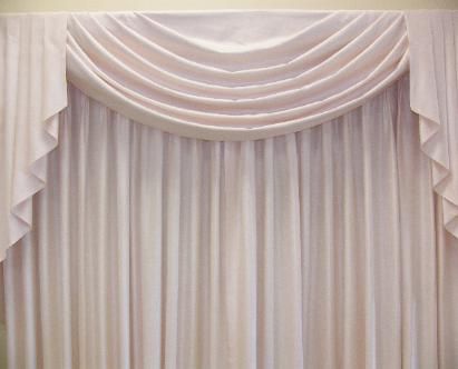 White drapery with a scalloped valance.