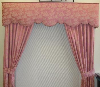 Pink curtains with matching scalloped valance.