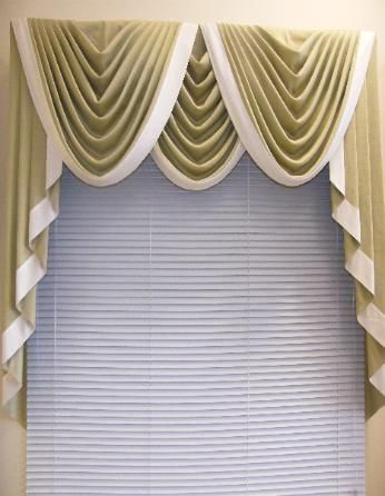 Tan and white window valance over blinds.