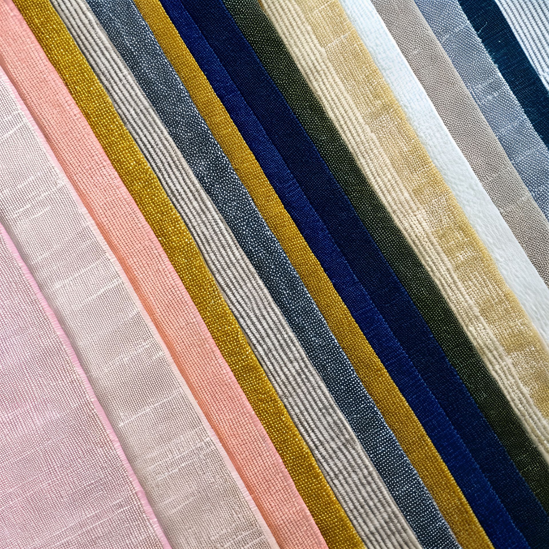 Assorted ribbons in pink, gold, navy, silver, and beige, with a shimmery, textured appearance.