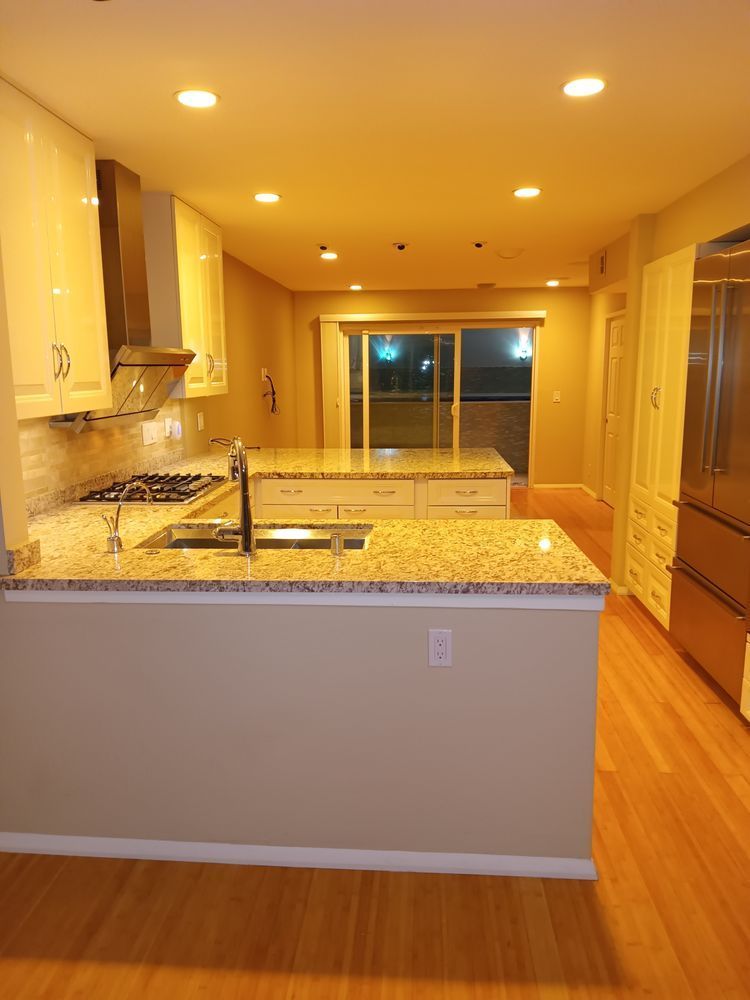 A kitchen with granite counter tops and stainless steel appliances
