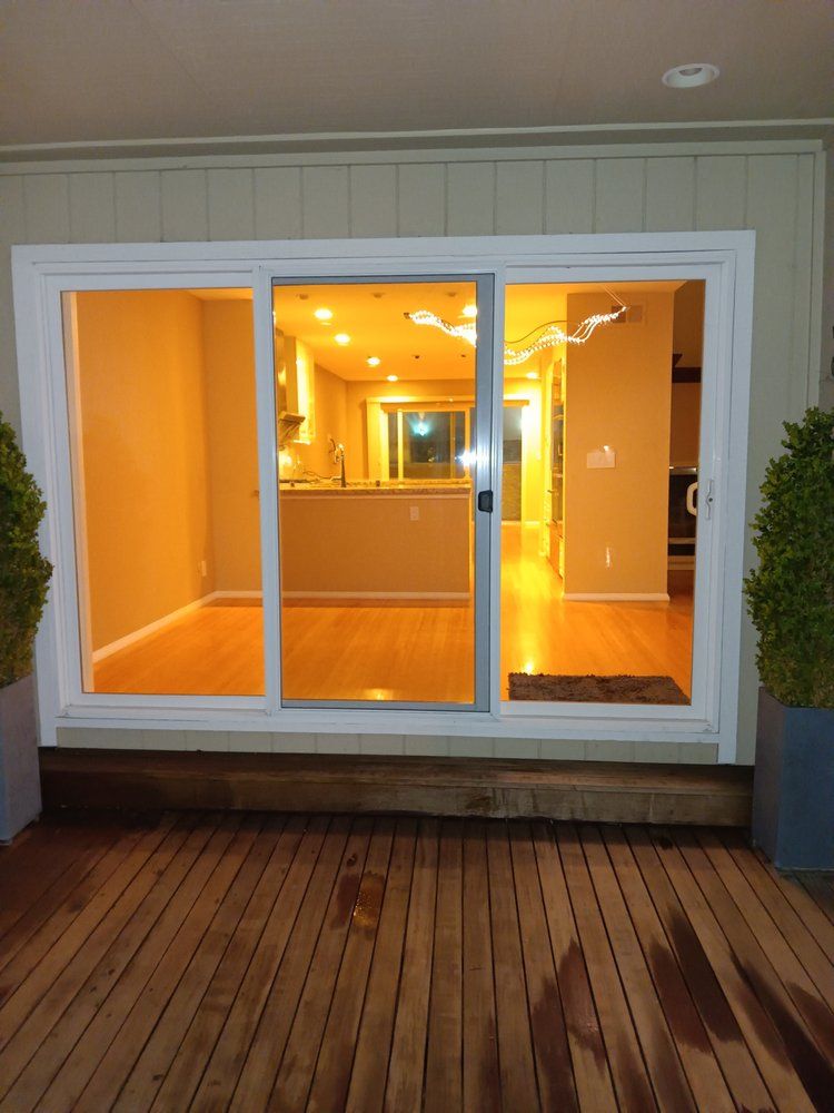 A sliding glass door opens to a kitchen