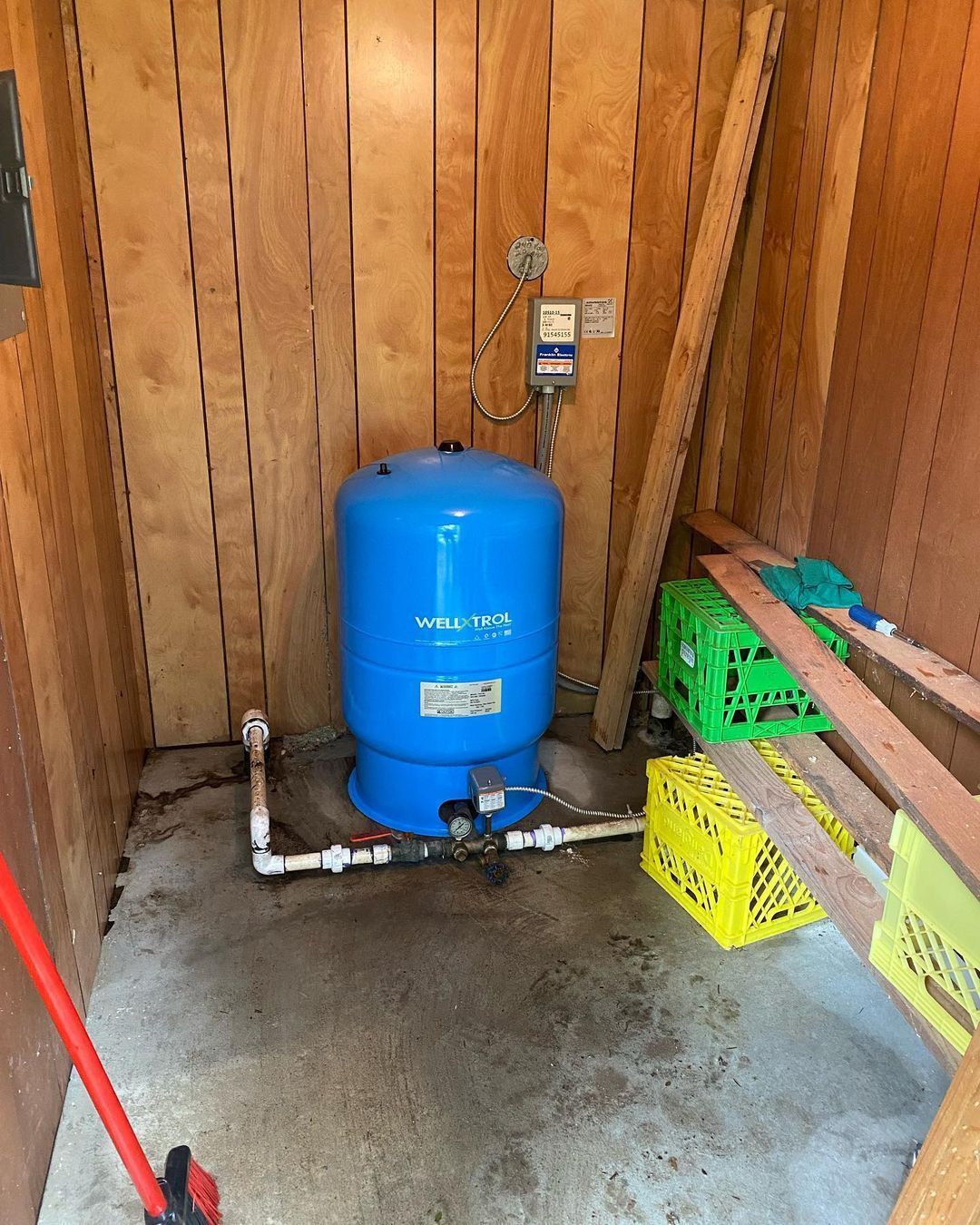 A blue water tank is sitting in a wooden room