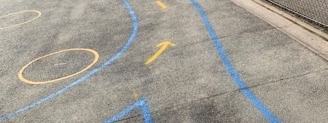 A chalk drawing of a circle and an arrow on the ground.