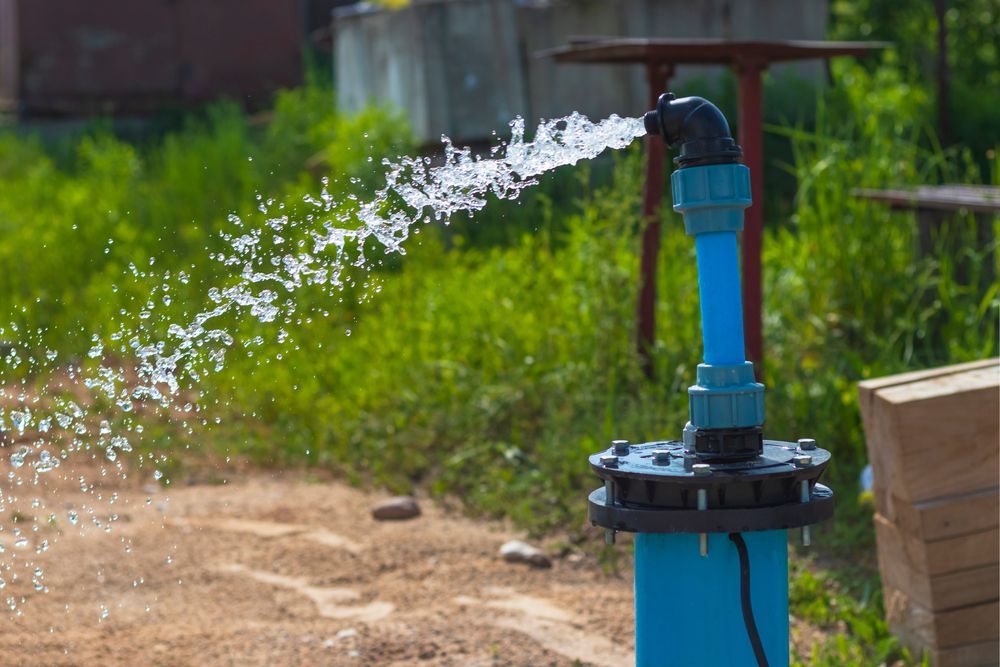 Water Gushing From a Blue Pipe, Spraying Into the Air — Wilson's Drilling in South Kolan, QLD