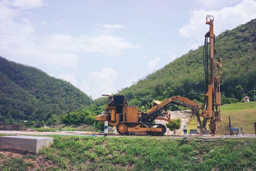 Yellow Drilling Rig on Tracks, Operates Near Mountains — Wilson's Drilling in Mount Perry, QLD