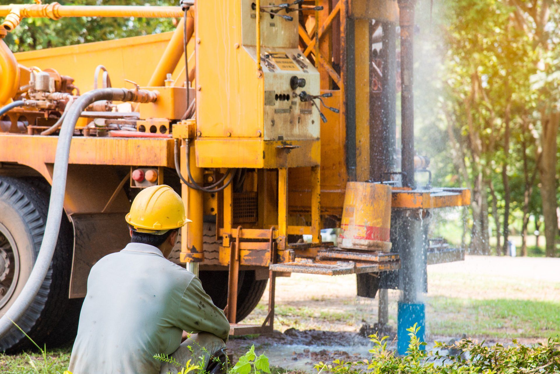 Worker in a Yellow Hard Hat Operates Drilling Equipment — Wilson's Drilling in Mount Perry, QLD