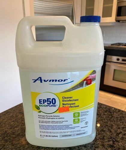 A gallon jug of Avmor EP50 disinfectant cleaner on a kitchen countertop.