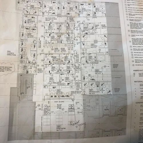 Black-and-white technical floor plan with dense room labels and dimensions on a gridded sheet