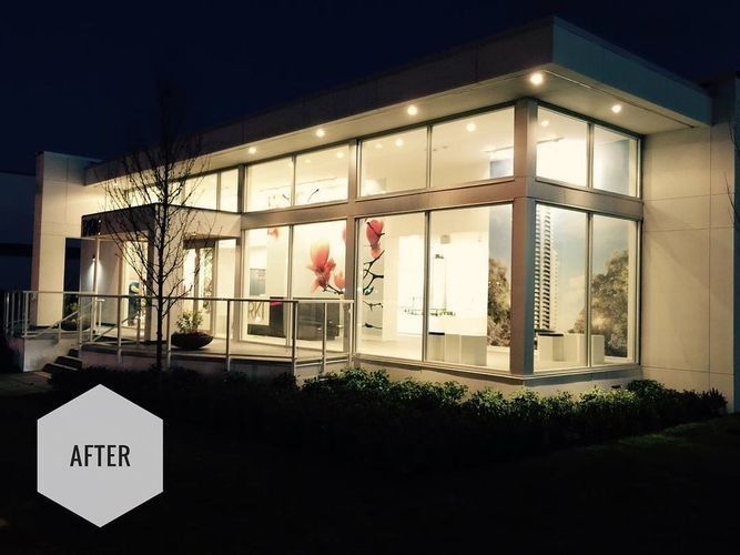 Nighttime exterior of a modern glass storefront with warm lights and an “AFTER” label.