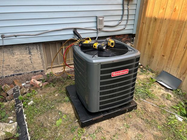 Copper coils wrapped around a large silver cylindrical HVAC unit.