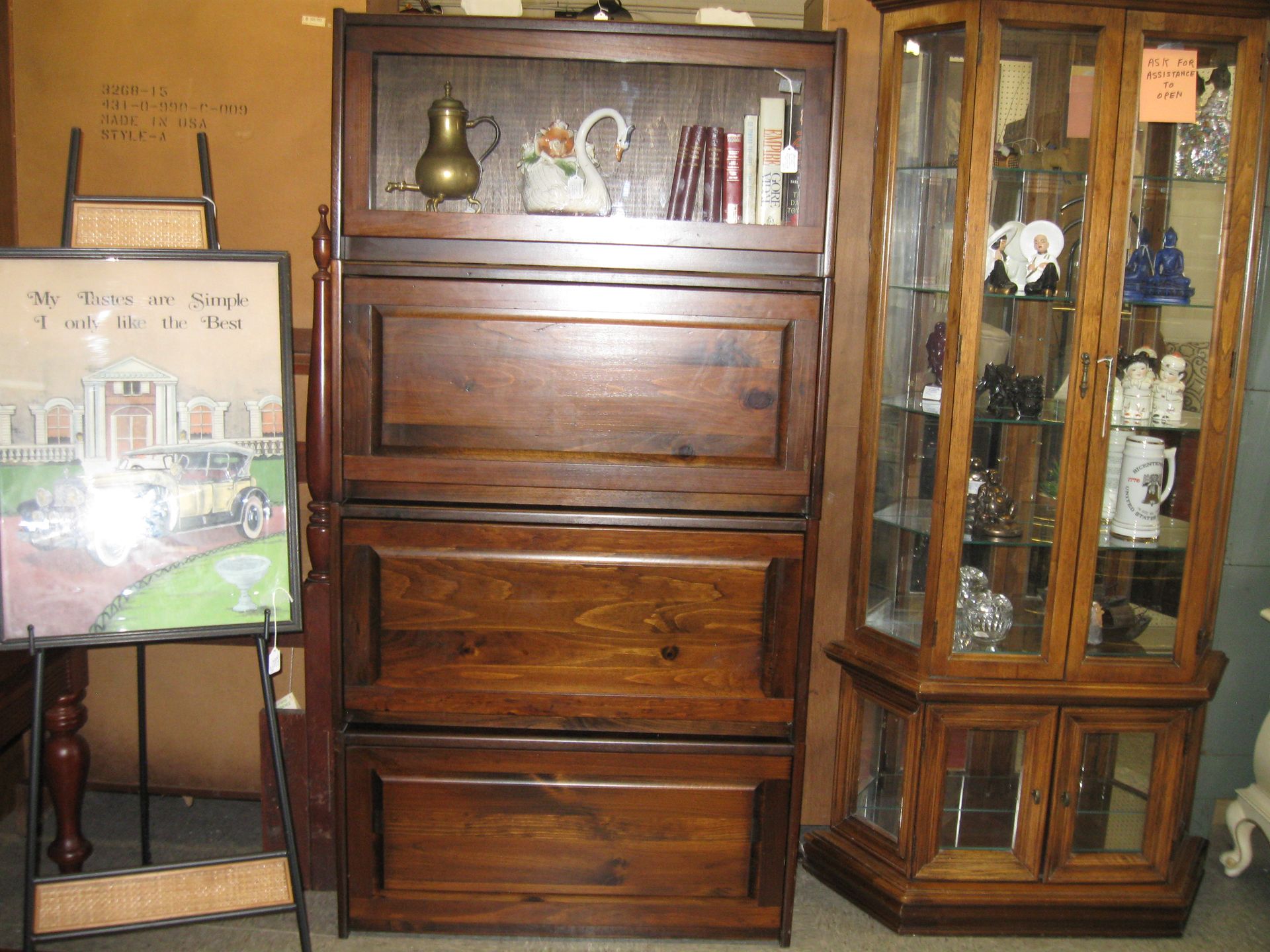 Antique wooden cabinet and glass display case in a vintage furniture room