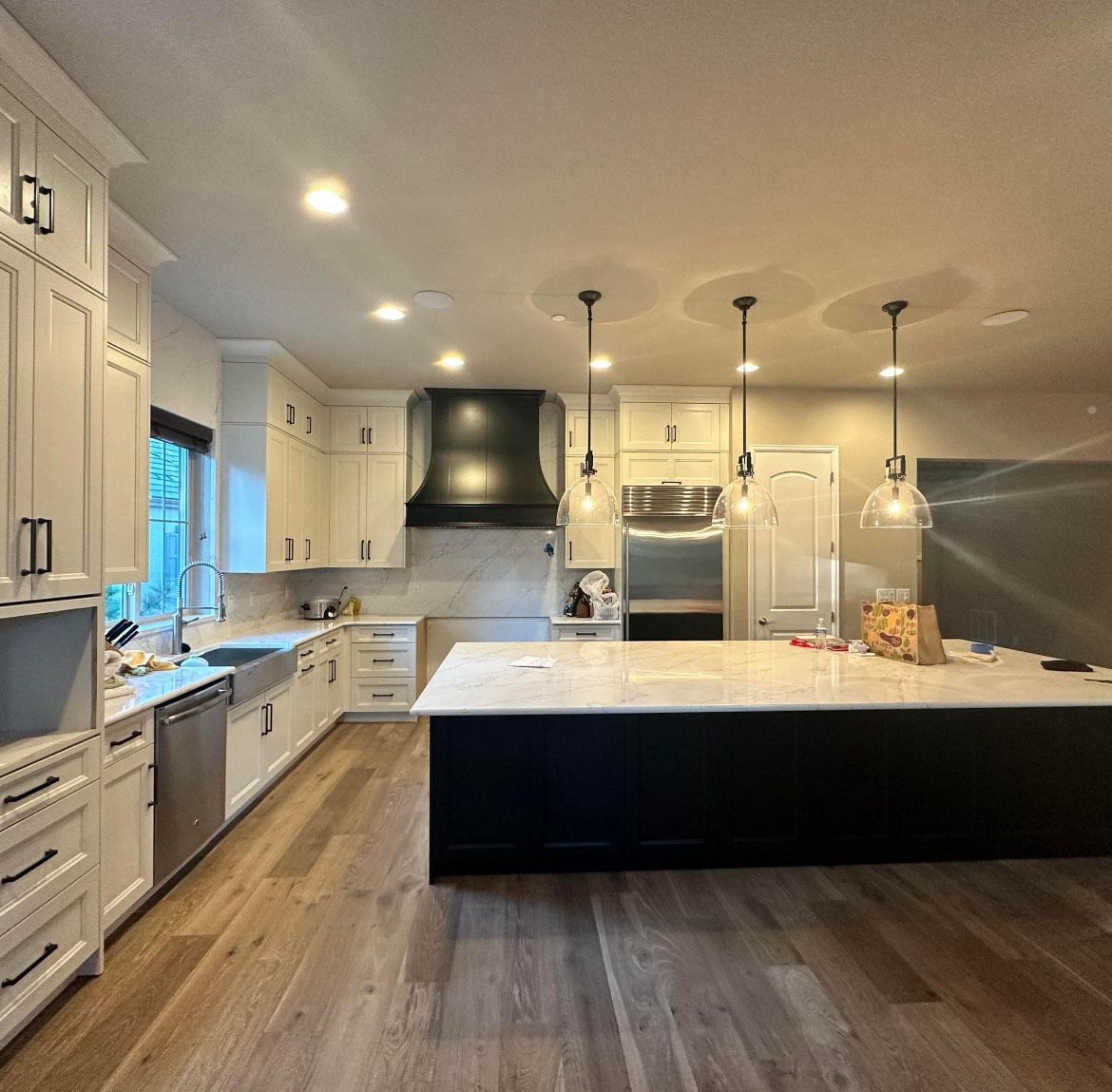 A kitchen with white cabinets and stainless steel appliances