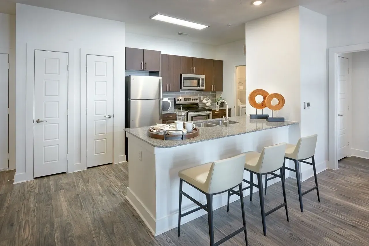Kitchen island with seating and modern appliances.