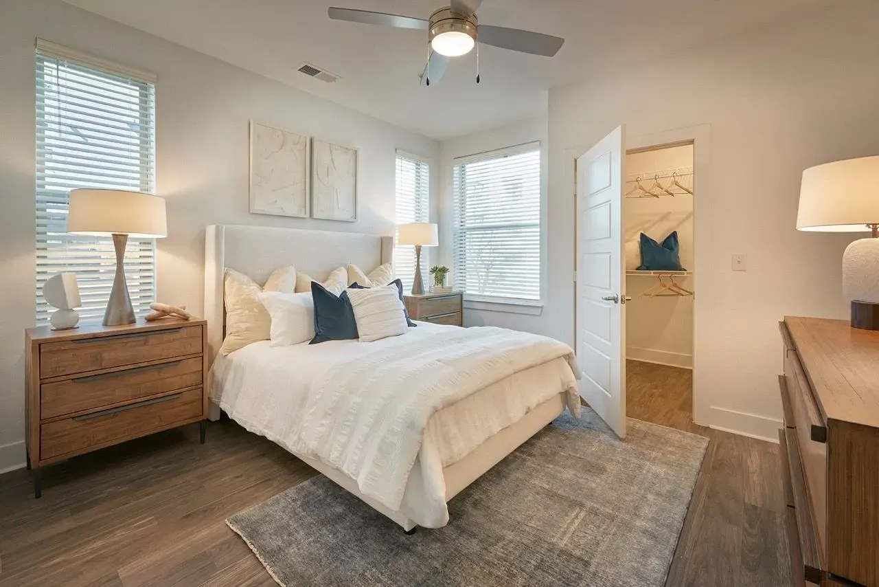 Bedroom with a queen-size bed, nightstands, dresser, closet, and ceiling fan.