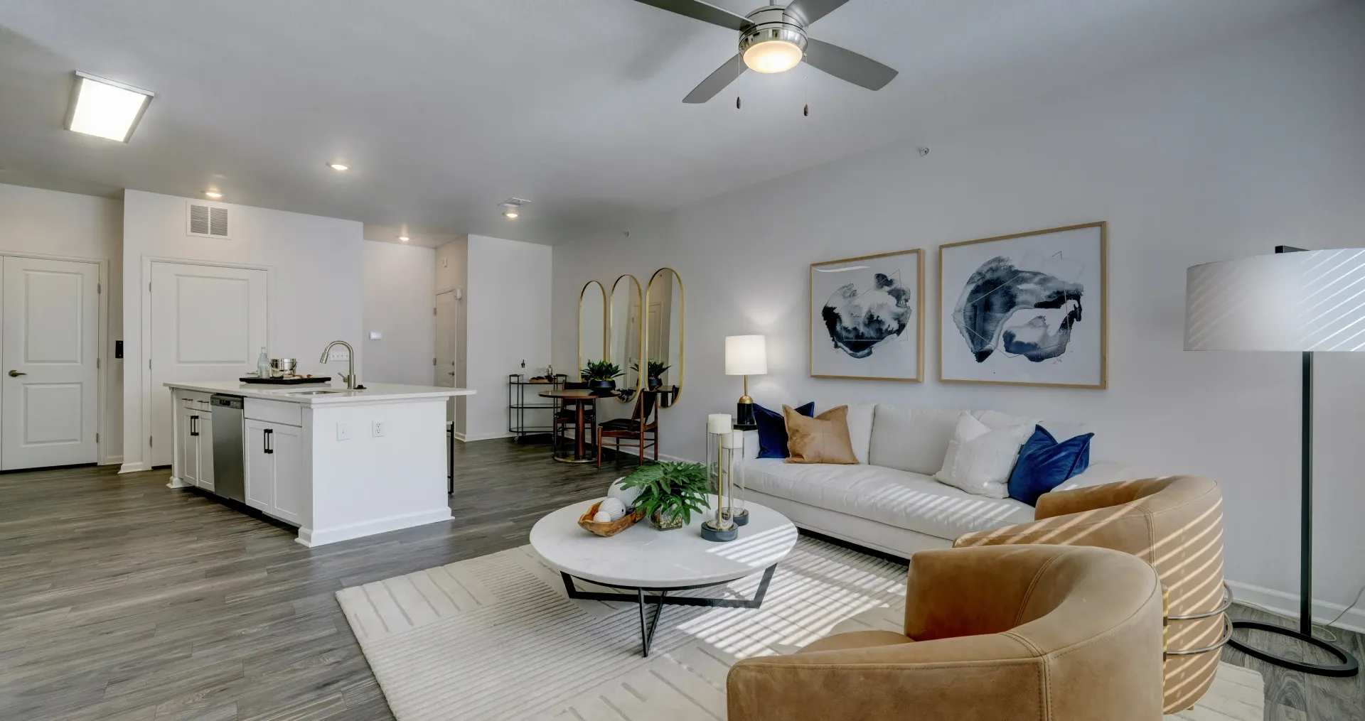Open concept living and kitchen area with modern furniture and decor.