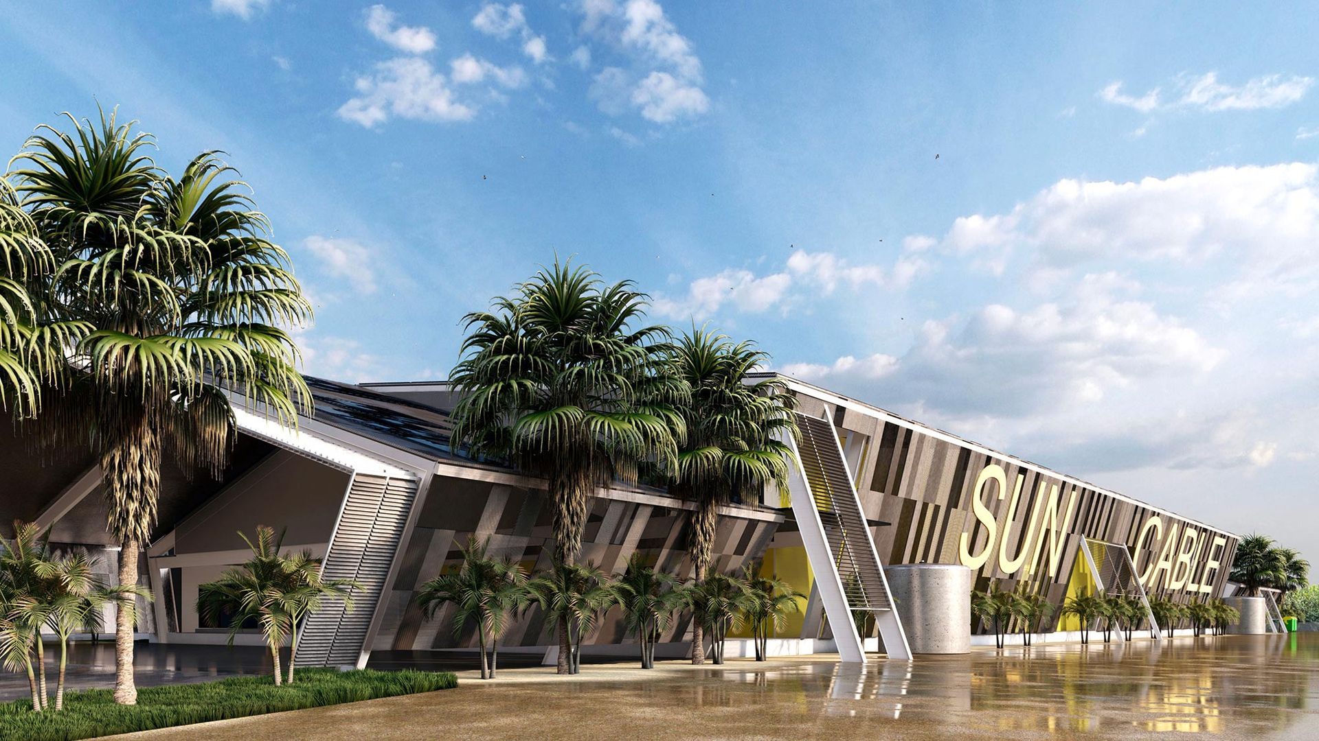 A modern, angled building facade with palm trees, a blue sky, and large text reading 