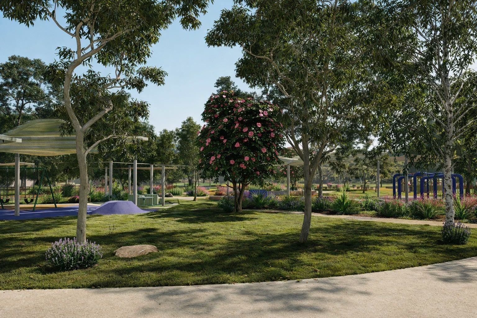 A sunny park featuring a central grassy area, mature trees, a flowering bush, and playground structures in the background.