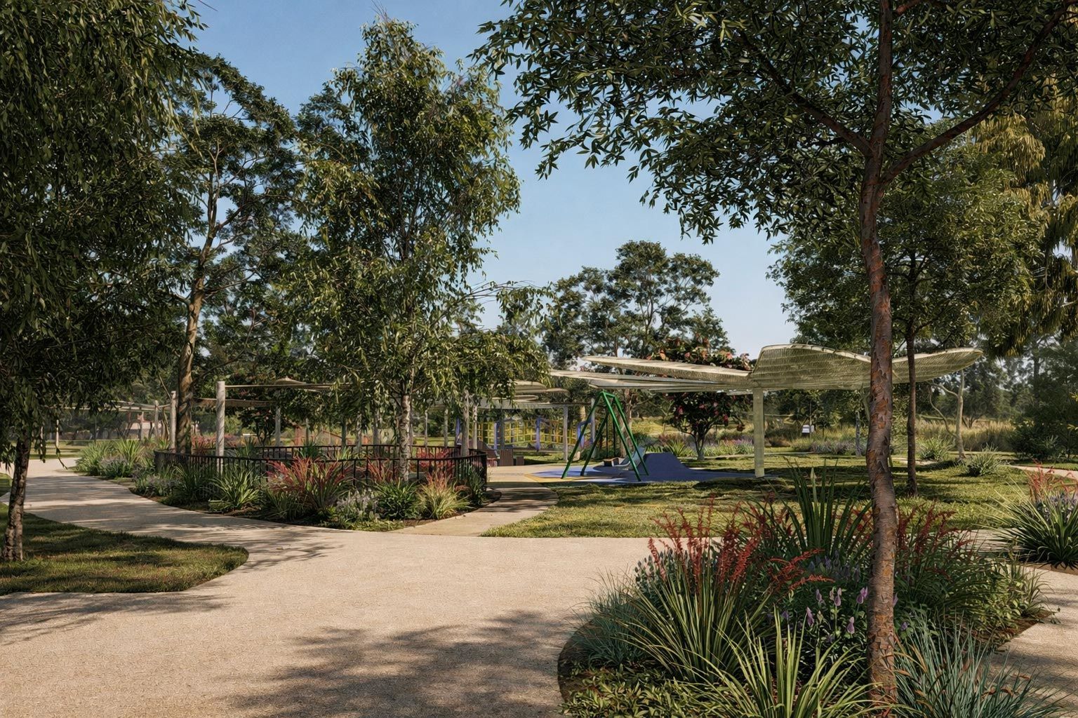 A gravel pathway winds through a sunny park filled with trees, garden beds, and a white, modern shade structure.