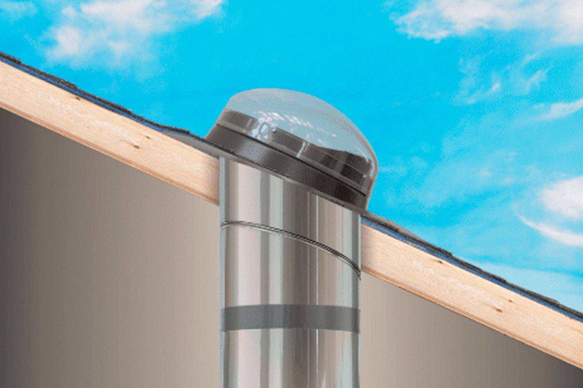 A tubular skylight dome mounted on a sloped roof against a blue sky.