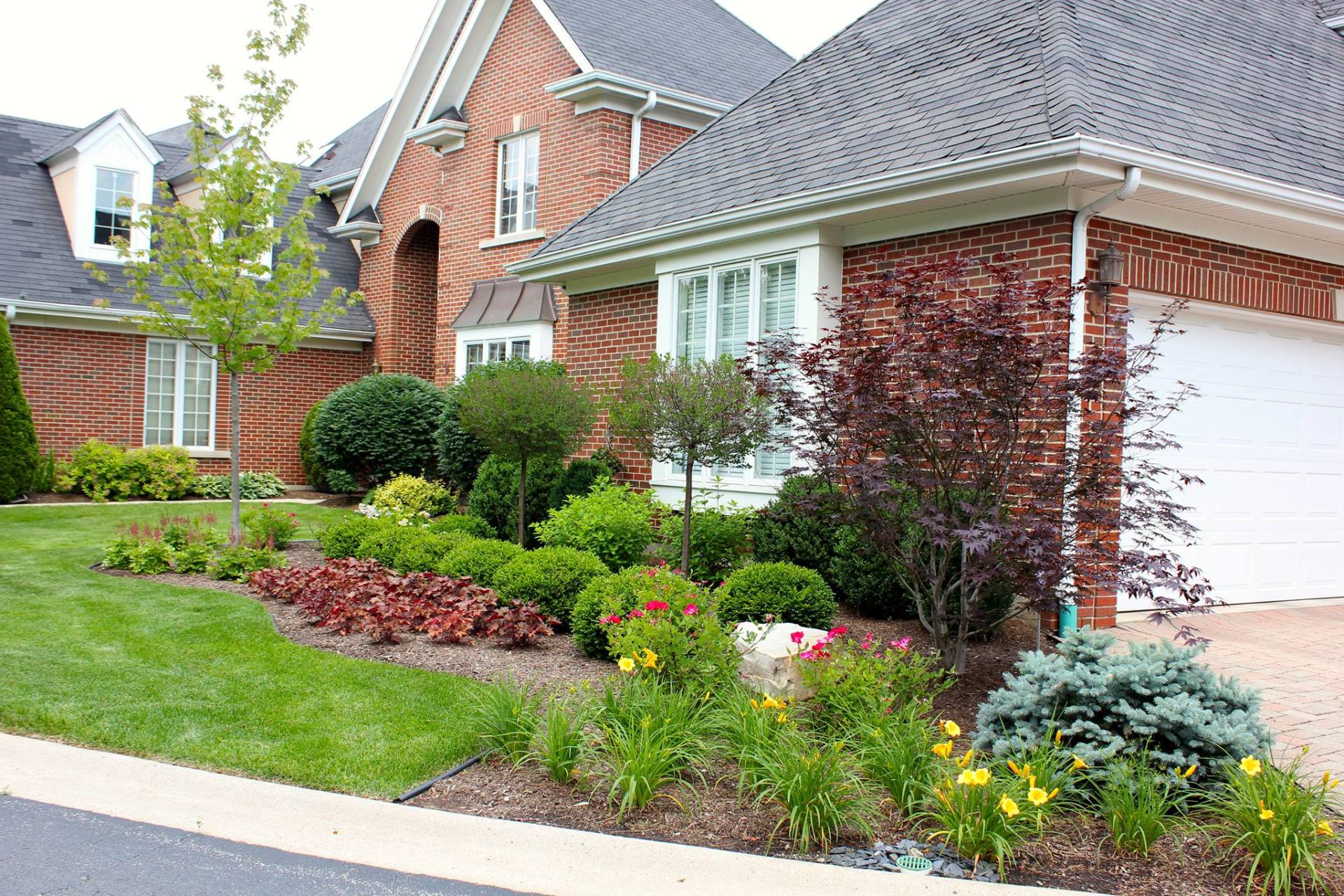 A large brick house with a white garage door