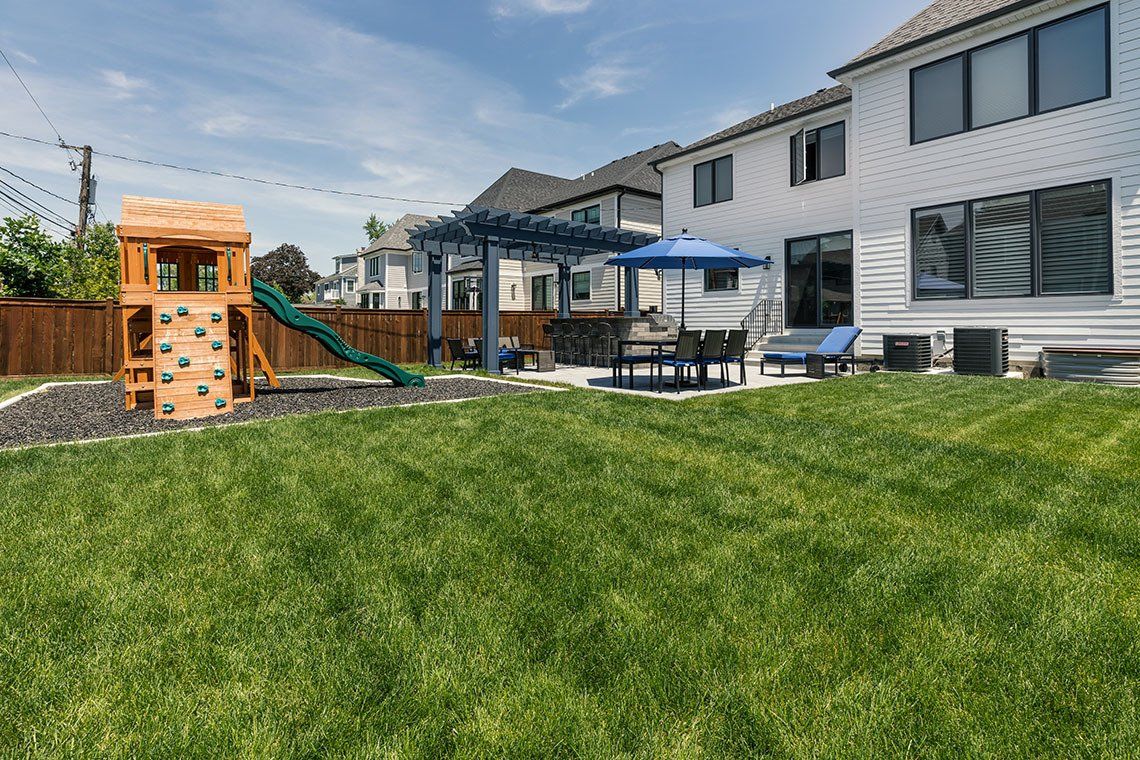 There is a playground in the backyard of a house.
