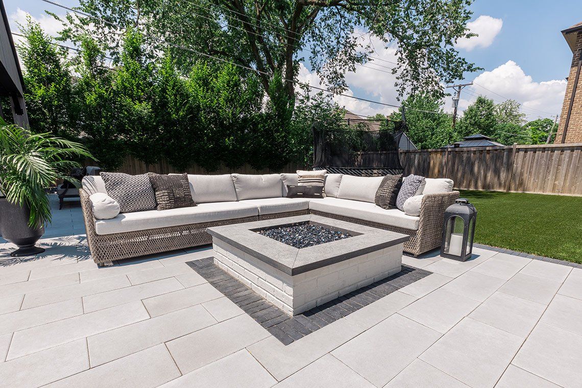 There is a fire pit in the middle of the patio.