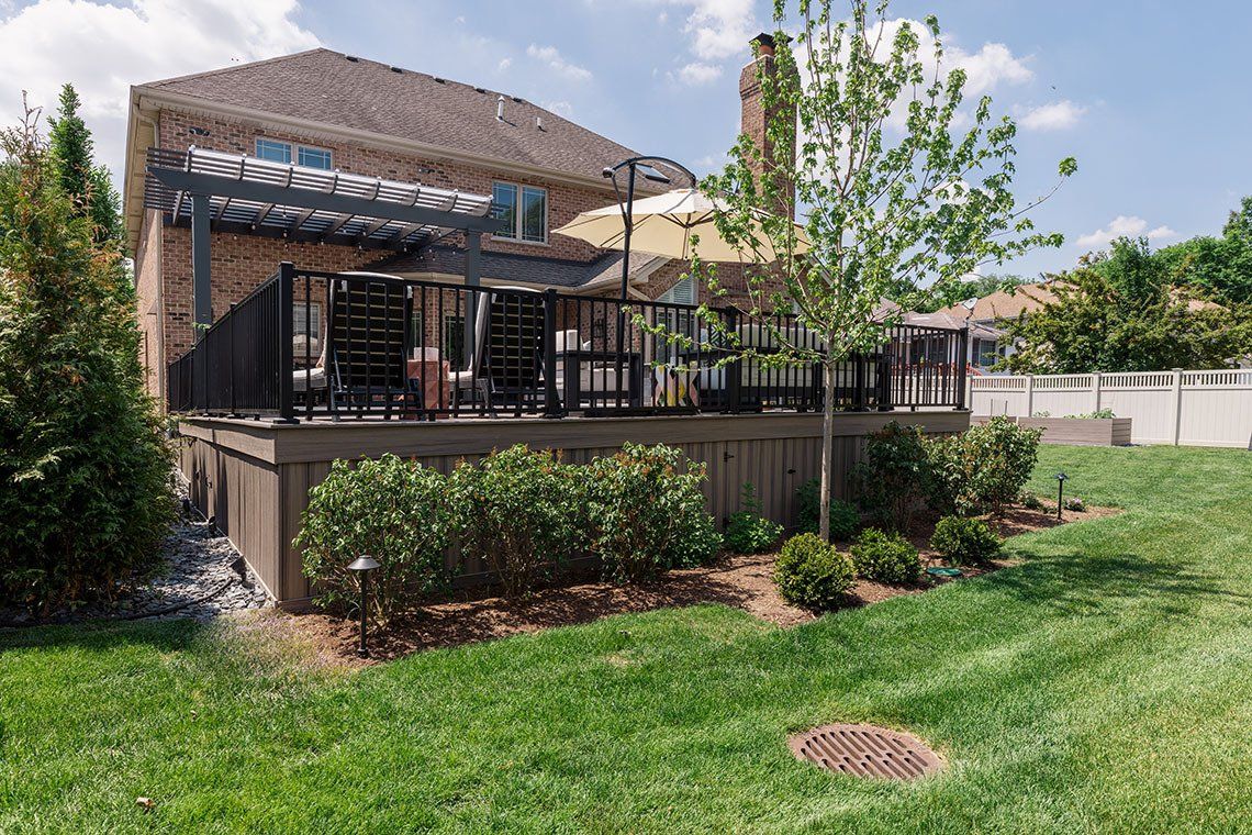 A large house with a large deck in the backyard.