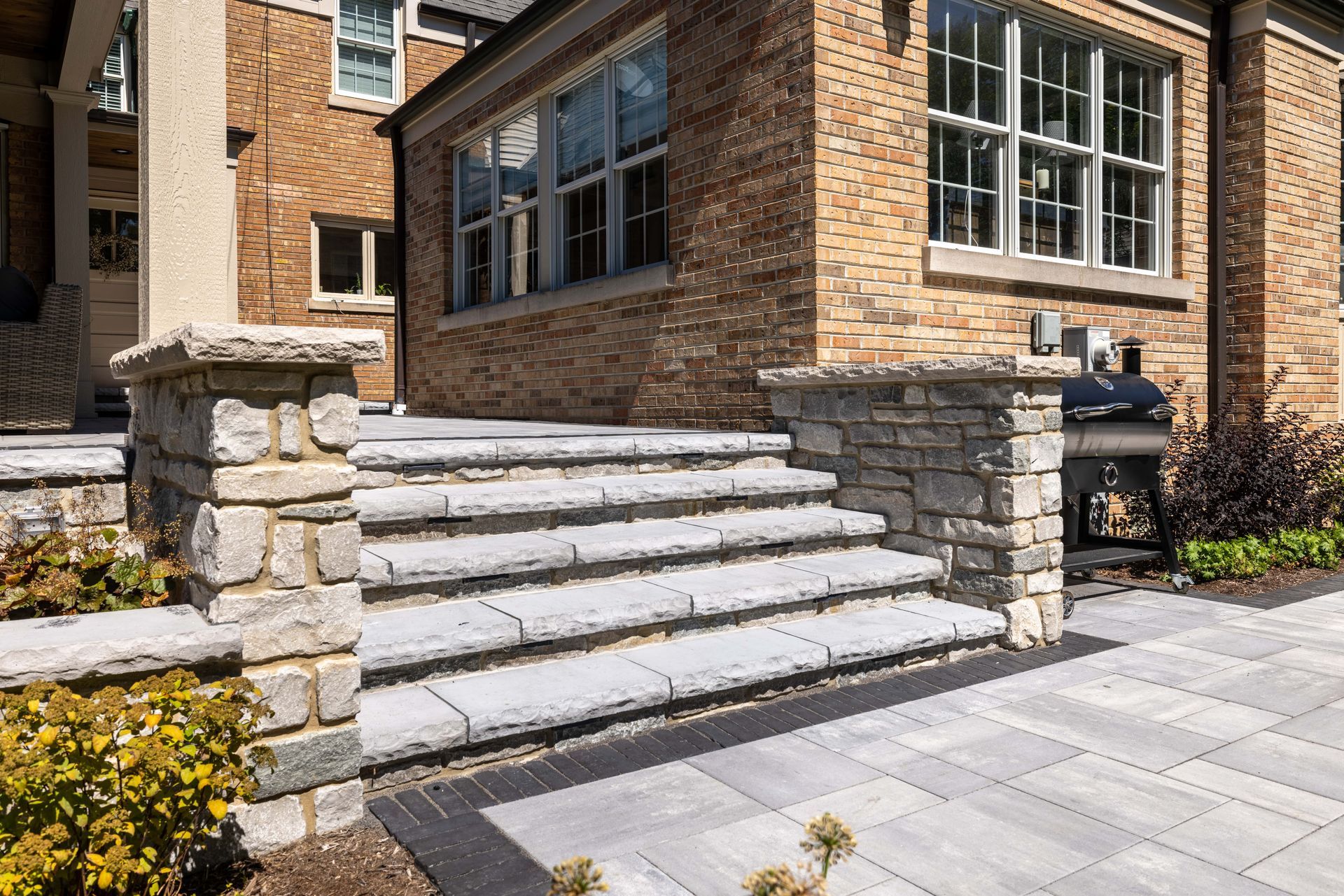 A brick house with stone steps leading up to it.